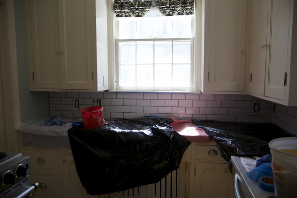 White subway tile backsplash installation